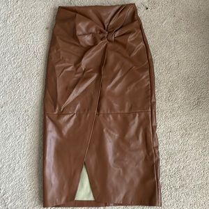 Tan faux leather midi skirt with slit size Small. New never worn.